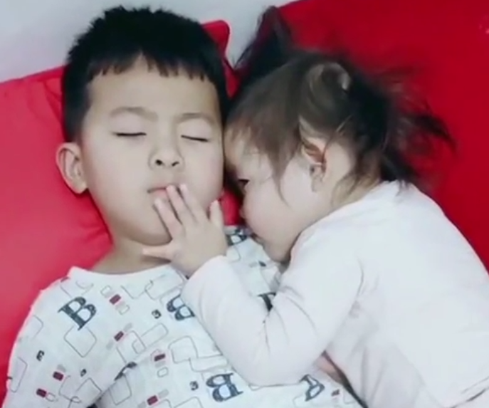 妹妹趁着哥哥睡觉，偷偷亲了哥哥一口，怕被发现的举动太萌了